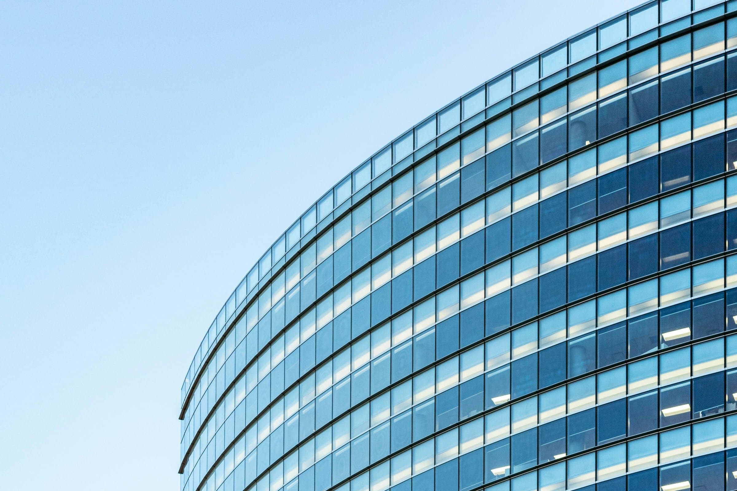 The curved glass facade of an office building